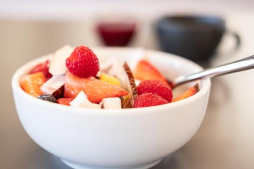 a bowl of fruit with a spoon in it at Elite Athlete Centre and Hotel in Loughborough