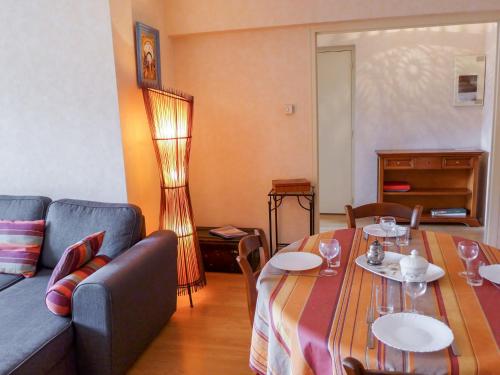 a living room with a couch and a table at Apartment Demeures de Maignon by Interhome in Anglet