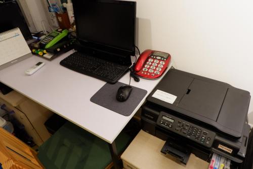 a desk with a laptop computer and a printer at Haru The Guesthouse in Andong