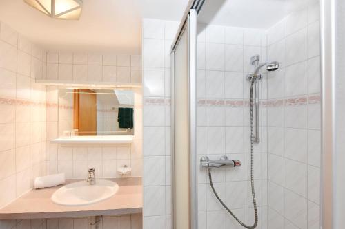 a bathroom with a shower and a sink at Landhaus Fuchsenstube in Schruns-Tschagguns