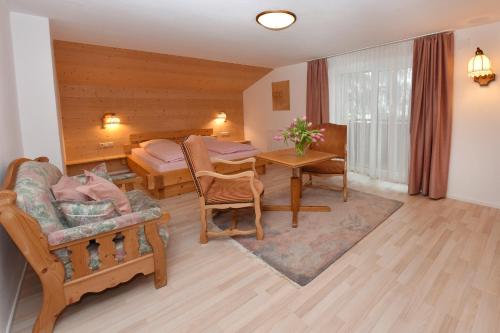 a living room with a table and a bedroom at Landhaus Fuchsenstube in Schruns-Tschagguns