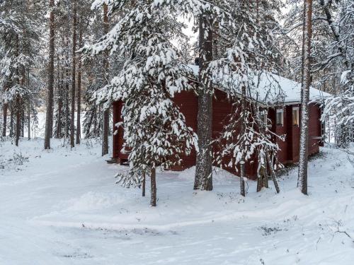ルカにあるHoliday Home Viipusjärvi 11 by Interhomeの雪が積もった森の赤い小屋
