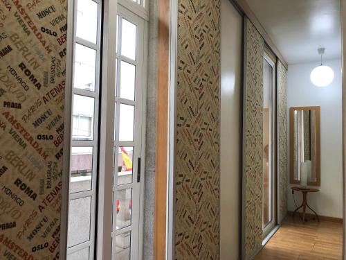 a hallway with a sliding door and a window at Hotel del Mar Vigo in Vigo
