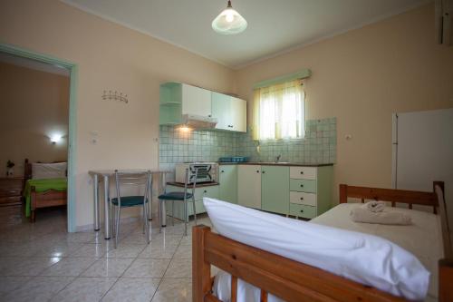 a kitchen with a bed and a table in a room at Eliza Apartments in Rethymno Town