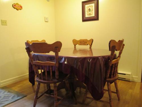 a table with two chairs and a table cloth on it at Comerford's Ocean View Suites in Holyrood