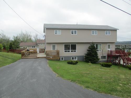 a large house with a driveway in front of it at Comerford's Ocean View Suites in Holyrood