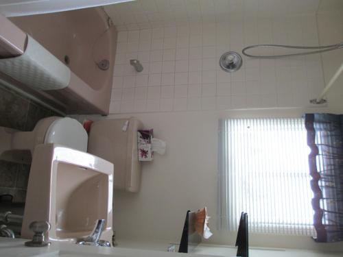 a bathroom with a sink and a window in it at Comerford's Ocean View Suites in Holyrood