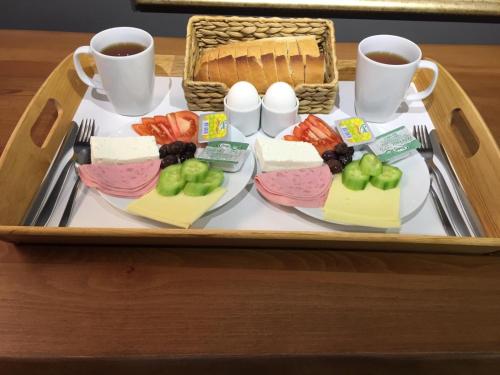 un vassoio di cibo con carne e frutta e due tazze di caffè di Hotel Miro Mansion Old City a Istanbul