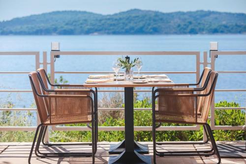 a table and chairs with a view of the water at Sun Gardens Dubrovnik in Dubrovnik