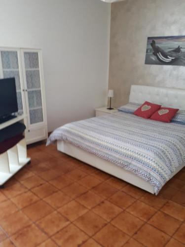 a bedroom with a bed and a flat screen tv at Casa Lilly in Beverino