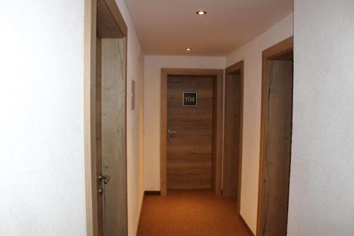 an empty hallway with a door in a room at Gletscher-Landhaus Brunnenkogel in Sankt Leonhard im Pitztal