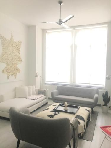 a living room with two beds and a couch at Les lofts de Styliste in Brussels