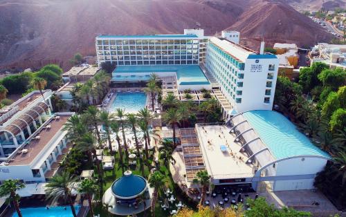 an overhead view of a hotel with a pool and palm trees at Yam Suf by Isrotel Collection in Eilat