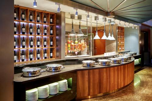 a restaurant with a counter with plates on it at Ambassador Hotel Hsinchu in Hsinchu City