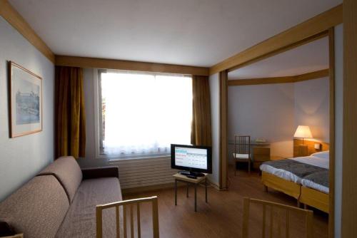a hotel room with a bed and a television at Inter-Résidences Paris XV in Paris