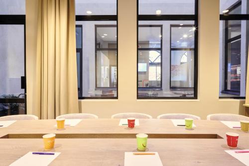 a row of tables and chairs in a room with windows at ibis Styles Marseille Gare Saint-Charles in Marseille