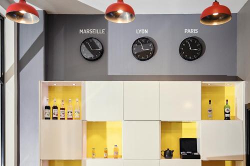 a store with clocks on the wall and bottles at ibis Styles Marseille Gare Saint-Charles in Marseille