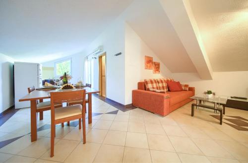 a living room with a table and a couch at Baška Point in Baška