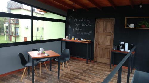 a dining room with two tables and a chalkboard on the wall at El Breton in Potrero de Garay