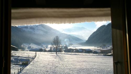 a window with a view of a snow covered mountain at Mattihus in Sankt Stephan