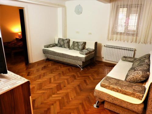 a living room with two couches and a wooden floor at Apartman La Linea - Free parking in Zagreb