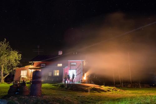 a house fire at night with smoke coming out of it at STF Tivedstorp in Tivedstorp