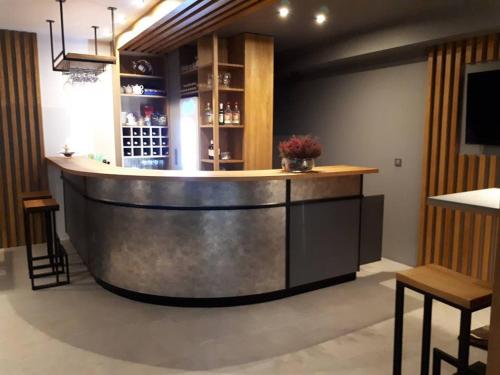 a bar in a restaurant with a counter and chairs at Hotel Amelia in Bydgoszcz