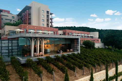 a building with a bunch of vines in front of it at Cramim by Isrotel Exclusive in Qiryat ‘Anavim