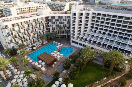 an aerial view of a building with a swimming pool at Sport Club by Isrotel Collection in Eilat