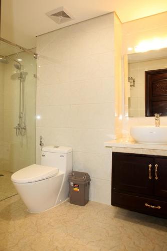 a bathroom with a toilet and a sink at Monaco Building Double Queen Bedroom in Hanoi