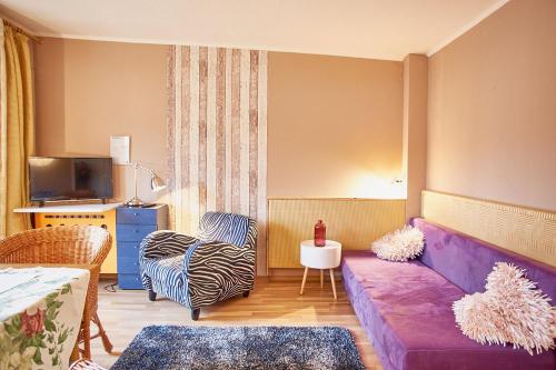 a living room with a purple couch and chairs at Ferienhaus Peggy in Kurort Oybin