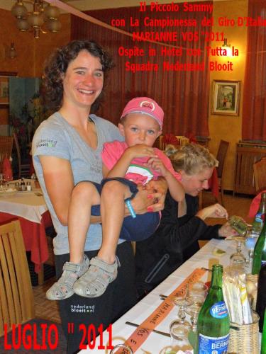 a woman holding a child on top of a table at Albergo Motel Dosdè B&B in Grosio