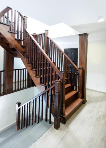 a staircase in a house with wooden railings at GORHouse Hotel in Yaremche