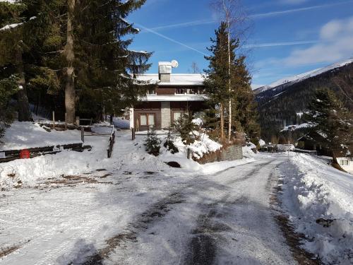a snow covered road in front of a house at Der Kristall by Globalimmoservice in Bad Kleinkirchheim