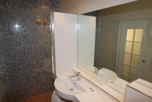 a bathroom with a sink and a mirror at Continental Parkhotel in Lugano