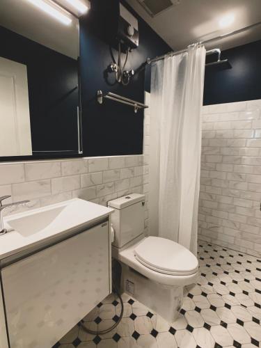 a bathroom with a white toilet and a sink at House 116 in Bangkok