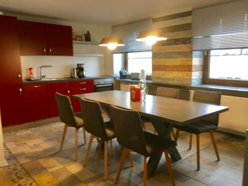 a kitchen with a wooden table and chairs at City Apartment in Nürnberg