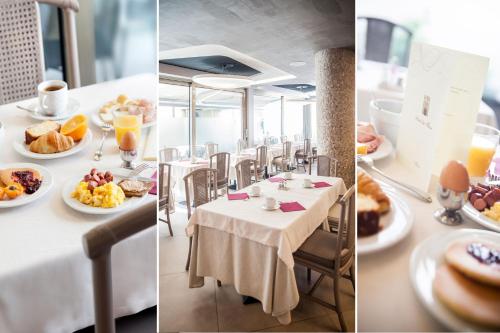 a table with plates of food on top at Hotel Dei Fiori Restaurant - Meeting & Spa in Alassio