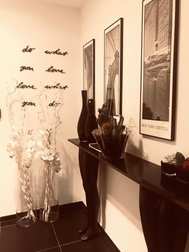 a room with a table with vases and birds on the wall at Les lofts de Styliste in Brussels