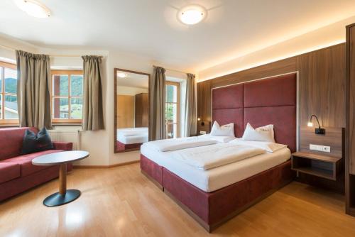 En eller flere senge i et værelse på Hotel Waldheim