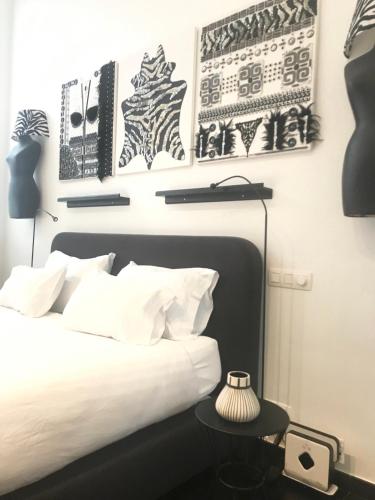 a bedroom with a bed with black and white art on the wall at Les lofts de Styliste in Brussels