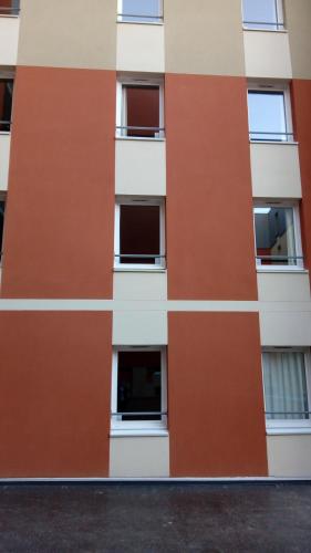 a facade of a building with windows at ibis budget Dieppe Centre Port in Dieppe