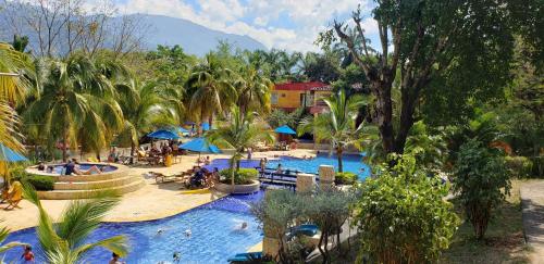 a resort with a large pool with people in it at Hotel Lagotours in San Jerónimo