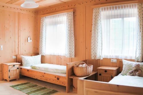 a bedroom with two beds and a window at Marhof Pustertal in Anras