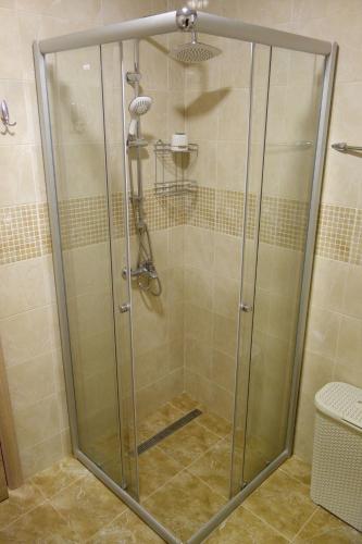 a shower with a glass door in a bathroom at Clementine in Sveti Stefan