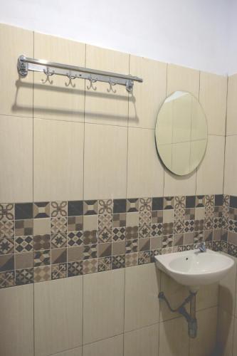 a bathroom with a sink and a mirror at Villa Cempaka Pangalengan in Cibeureum