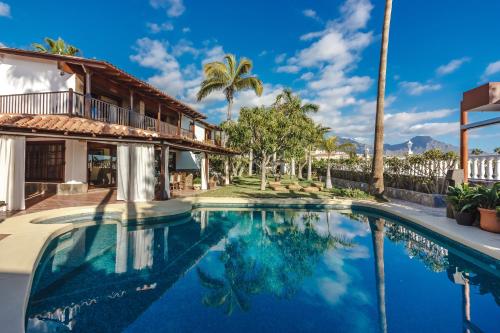 a swimming pool in front of a house at Finca Santa Maria in Callao Salvaje