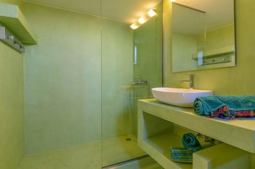 a bathroom with a sink and a glass shower at Villa Sophia in Agios Nikolaos