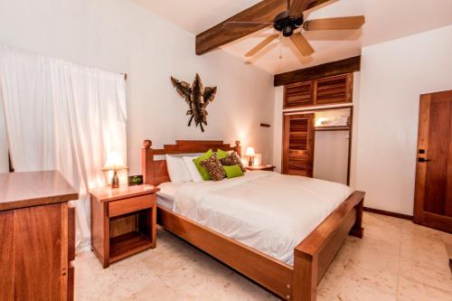 a bedroom with a bed and a ceiling fan at Indigo Belize 1B Condo in San Pedro