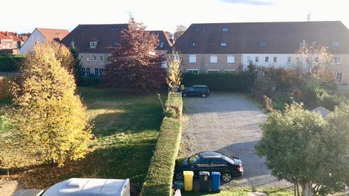 a parking lot with a car parked in a yard at FANTASIA a spacious beautiful apartment & affordable in Nossegem